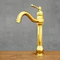 Gold freestanding basin mixer tap in satin brass