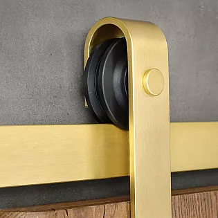 Sliding door system made of steel in golden color, for single-leaf doors up to 100 kg, wall-mounted